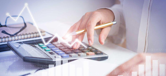 Accountant calculating profit with financial analysis graphs