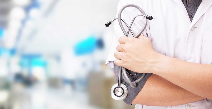Doctor with a stethoscope in the hands and hospital background