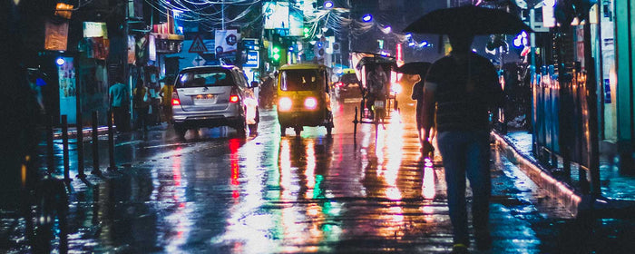 Street lights reflecting on wet city streets in India